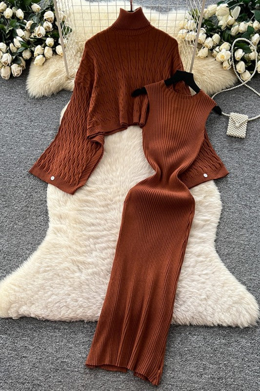 Brown ribbed sweater set on a white textured surface with decorative flowers in the background.