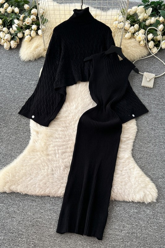 Black ribbed sweater and pants set on a white fur surface with floral decorations.