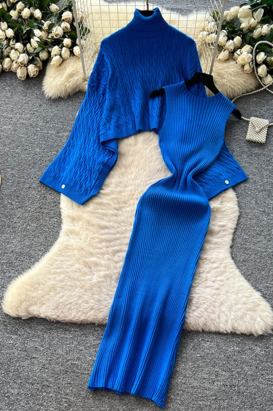 Blue knit outfit on a textured surface with decorative elements